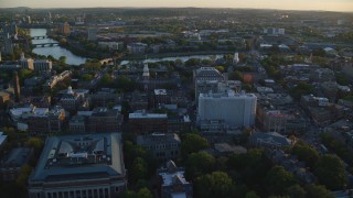 AX146_037 - 6k stock footage aerial video flying over Harvard University, approaching Charles River, Massachusetts, sunset