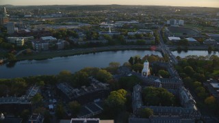 AX146_038 - 6k aerial stock footage approaching Harvard Business School, Harvard University, Massachusetts, sunset