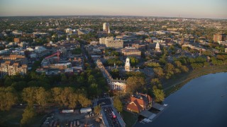 AX146_043 - 6k stock footage aerial video approaching Eliot House from Charles River, Harvard University, Massachusetts, sunset