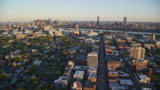 AX146_047 - 6k aerial stock footage flying by office buildings, Downtown Boston skyline, Cambridge, Massachusetts, sunset 
