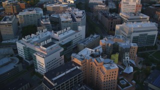 AX146_054 - 6k stock footage aerial video flying over buildings, Massachusetts Institute of Technology, Massachusetts, sunset