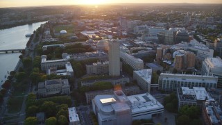 AX146_057 - 6k aerial stock footage flying by the Massachusetts Institute of Technology, Massachusetts, sunset