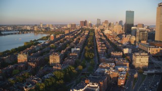 AX146_062 - 6k stock footage aerial video flying over Back Bay, approaching Downtown Boston, Massachusetts, sunset
