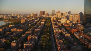 AX146_062E - 6k aerial stock footage flying over Back Bay, approach Boston Common, Downtown Boston, Massachusetts, sunset