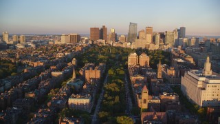 AX146_064 - 6k aerial stock footage approaching Boston Common, Downtown Boston, Massachusetts, sunset