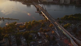 AX146_066 - 6k aerial stock footage flying by the Longfellow Bridge, Charles River, Boston, Massachusetts, sunset