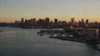 AX146_077 - 6k aerial stock footage flying over Charles River, approaching Downtown Boston, Massachusetts, sunset