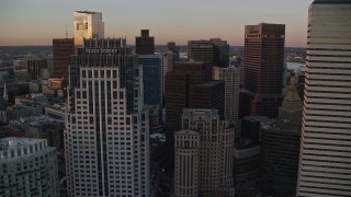 AX146_085 - 6k aerial stock footage of One Financial Center, One Lincoln Street, Downtown Boston, Massachusetts, sunset