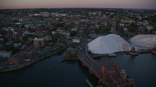 AX146_098 - 6k aerial stock footage flying by apartment buildings, Chelsea, Massachusetts, sunset