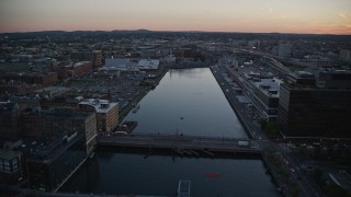 AX146_112 - 6k aerial stock footage flying over Fort Point Channel, Downtown Boston, Massachusetts, twilight