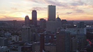 AX146_113 - 6k aerial stock footage flying by downtown skyscrapers, Downtown Boston, Massachusetts, sunset