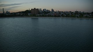 AX146_118 - 6k aerial stock footage flying by waterfront homes, apartments, South Boston, Massachusetts, twilight