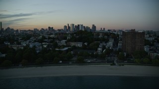 AX146_119E - 6k aerial stock footage of Waterfront homes, Dorchester Heights Monument, South Boston, Massachusetts, twilight