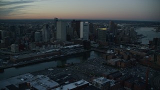 AX146_123E - 6k aerial stock footage of Fort Point Channel, Downtown Boston, Massachusetts, twilight