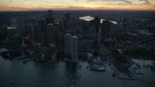 AX146_127E - 6k aerial stock footage flying by skyscrapers, Downtown Boston, Massachusetts, twilight