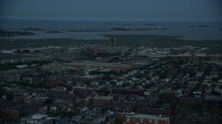 AX146_131 - 6k aerial stock footage flying by Logan International Airport, Boston, Massachusetts, twilight