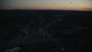 AX146_153 - 6k aerial stock footage approaching suburban neighborhoods, Roslindale, Massachusetts, twilight