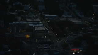 AX146_154E - 6k aerial stock footage flying by Washington Street, Roslindale, Massachusetts, night