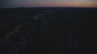 AX146_157 - 6k aerial stock footage flying over suburban neighborhood, Hyde Park, Massachusetts, night