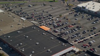 AX147_005 - 6K aerial stock footage flying by a shopping mall and parking lot with cars, Dorchester, Massachusetts