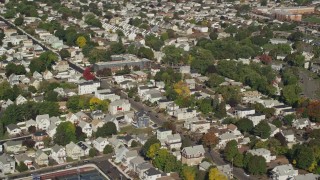 AX147_013 - 6K aerial stock footage flying away from suburban neighborhood and tree lined streets, Chelsea, Massachusetts