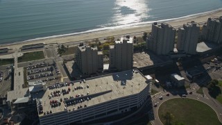 AX147_014 - 6K aerial stock footage flying over parking garage and beachfront condominiums, Revere, Massachusetts