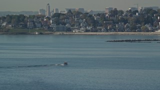AX147_015 - 6k aerial stock footage of a fishing boat on Broad Sound, revealing waterfront homes, Revere, Massachusetts