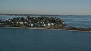 AX147_016E - 6K aerial stock footage approaching houses in a coastal community on a peninsula, Nahant, Massachusetts