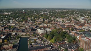 AX147_036E - 6K aerial stock footage flying over canal, warehouses and office buildings, Salem, Massachusetts