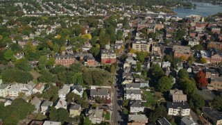 AX147_040 - 6K aerial stock footage orbiting residential homes and office buildings, autumn, Salem, Massachusetts