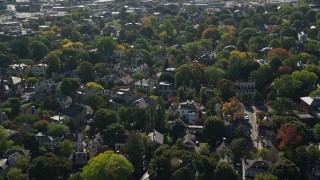AX147_045E - 6K aerial stock footage flying over a residential neighborhood in autumn, Salem, Massachusetts