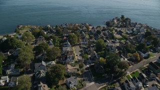 AX147_052 - 6K aerial stock footage flying over coastal homes, Salem, Massachusetts