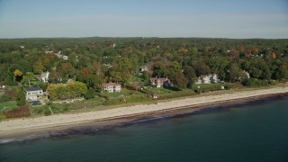 AX147_057E - 6K aerial stock footage flying by beachfront mansions and fall foliage, autumn, Beverly, Massachusetts