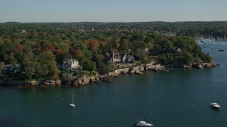 AX147_059E - 6K aerial stock footage flying along oceanfront homes and fall foliage, Manchester-by-the-Sea, Massachusetts