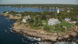 AX147_063 - 6K aerial stock footage orbiting away from oceanfront mansions among fall foliage, Manchester-by-the-Sea, Massachusetts