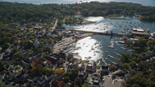 AX147_069E - 6K aerial stock footage flying away from a coastal community and harbor, autumn, Manchester-by-the-Sea, Massachusetts