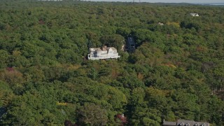 AX147_078 - 6K aerial stock footage flying by mansion, dense trees, autumn, Manchester-by-the-Sea, Massachusetts