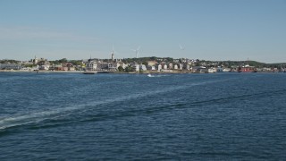 AX147_084E - 6K aerial stock footage flying low over Gloucester Harbor, approach coastal town, Gloucester, Massachusetts
