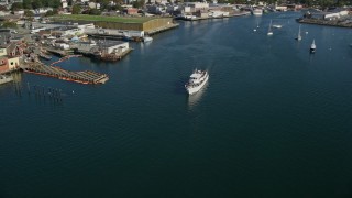 AX147_088 - 6K aerial stock footage tracking a ferry by a small coastal town, Gloucester, Massachusetts