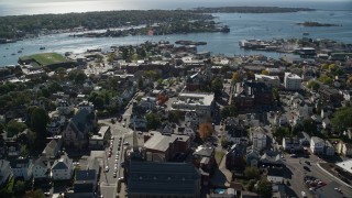 AX147_101E - 6K aerial stock footage orbiting away form a city hall in a coastal town, Gloucester, Massachusetts