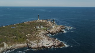 AX147_110 - 6k aerial stock footage approaching two lighthouses on an island, Thatcher Island, Massachusetts