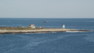 AX147_115E - 6K aerial stock footage approaching a lighthouse, Straitsmouth Island, Rockport, Massachusetts