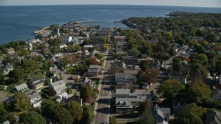 AX147_126E - 6K aerial stock footage flying over coastal town and Broadway toward harbor, Rockport, Massachusetts