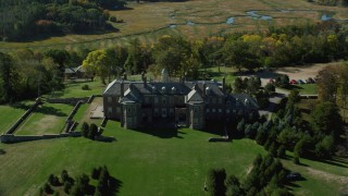 AX147_140 - 6k aerial stock footage approaching and flying over The Great House at Crane Estate on Castle Hill, Autumn, Ipswich, Massachusetts