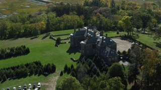 AX147_145 - 6k aerial stock footage of a side view of The Great House at Crane Estate on Castle Hill in autumn, Ipswich, Massachusetts