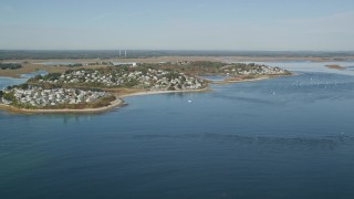 AX147_150 - 6k aerial stock footage approaching a coastal town in autumn, Ipswich, Massachusetts