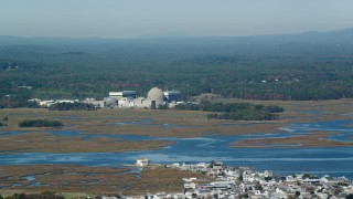 AX147_152 - 6k aerial stock footage of a nuclear power plant along the water, autumn, Seabrook, New Hampshire