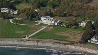 AX147_160E - 6K aerial stock footage oceanfront mansion in autumn, North Hampton, New Hampshire