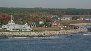 AX147_162 - 6K aerial stock footage flying by oceanfront homes and new construction, autumn, Rye, New Hampshire