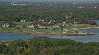 AX147_170 - 6K aerial stock footage flying by waterfront mansions, autumn, Rye, New Hampshire